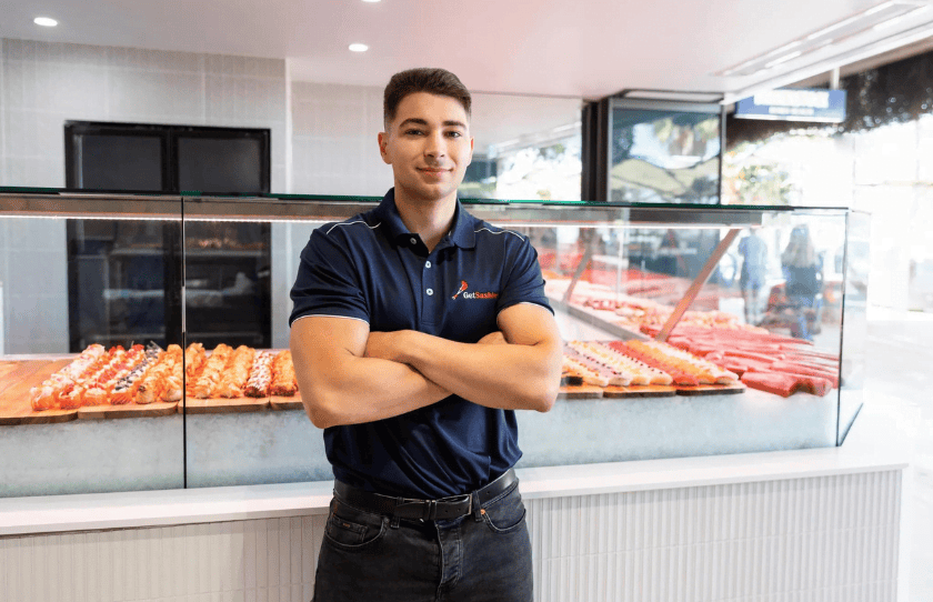 Get Sashimi owner Antonio Muollo standing proudly infront of fresh sashimi display in store.